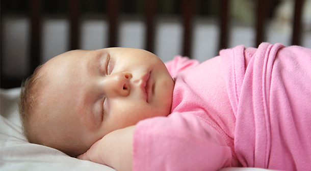 Babies should sleep on their backs in a room that is cool and free of any cigarette smoke. 